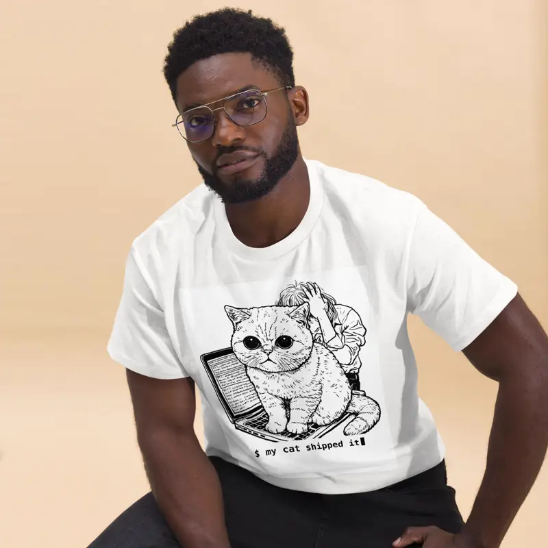 White tee printed with a grumpy cat on a laptop and the line “$ my cat shipped it”